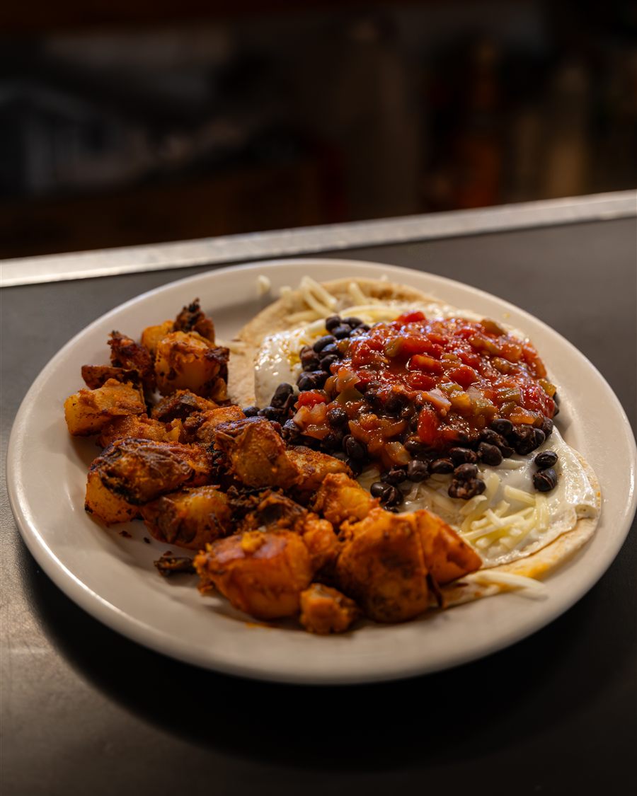 Huevos rancheros with black beans, salsa and home-fries